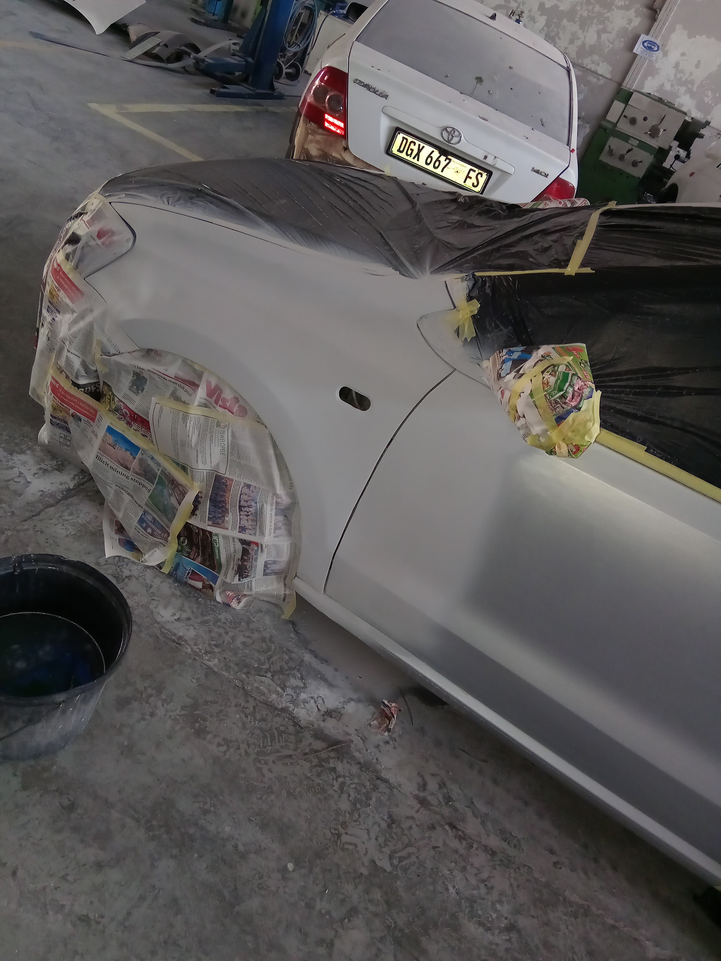 Vehicle masked for paint preparation inside the workshop