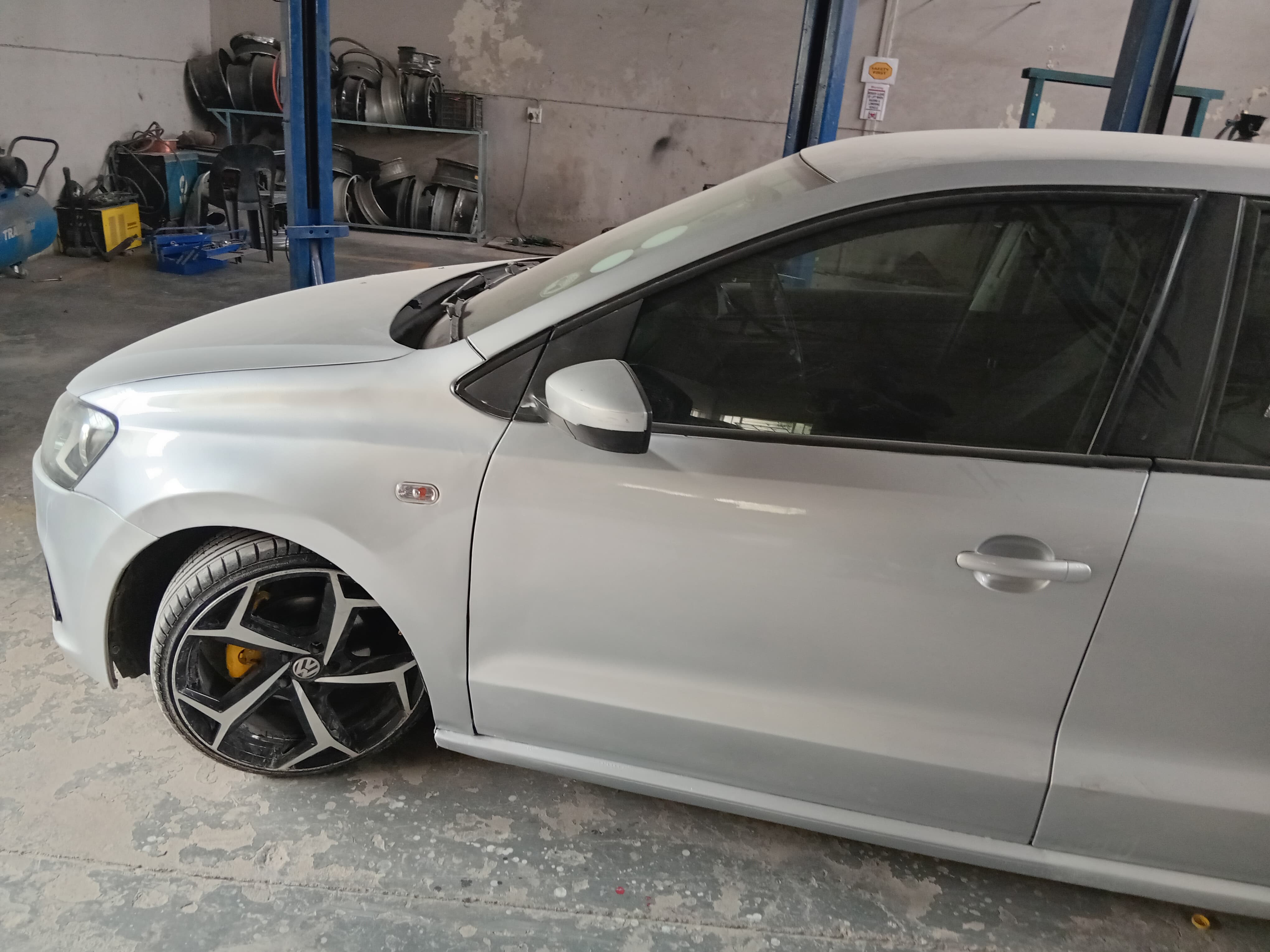 Vehicle with finished black and silver mag wheel in the workshop