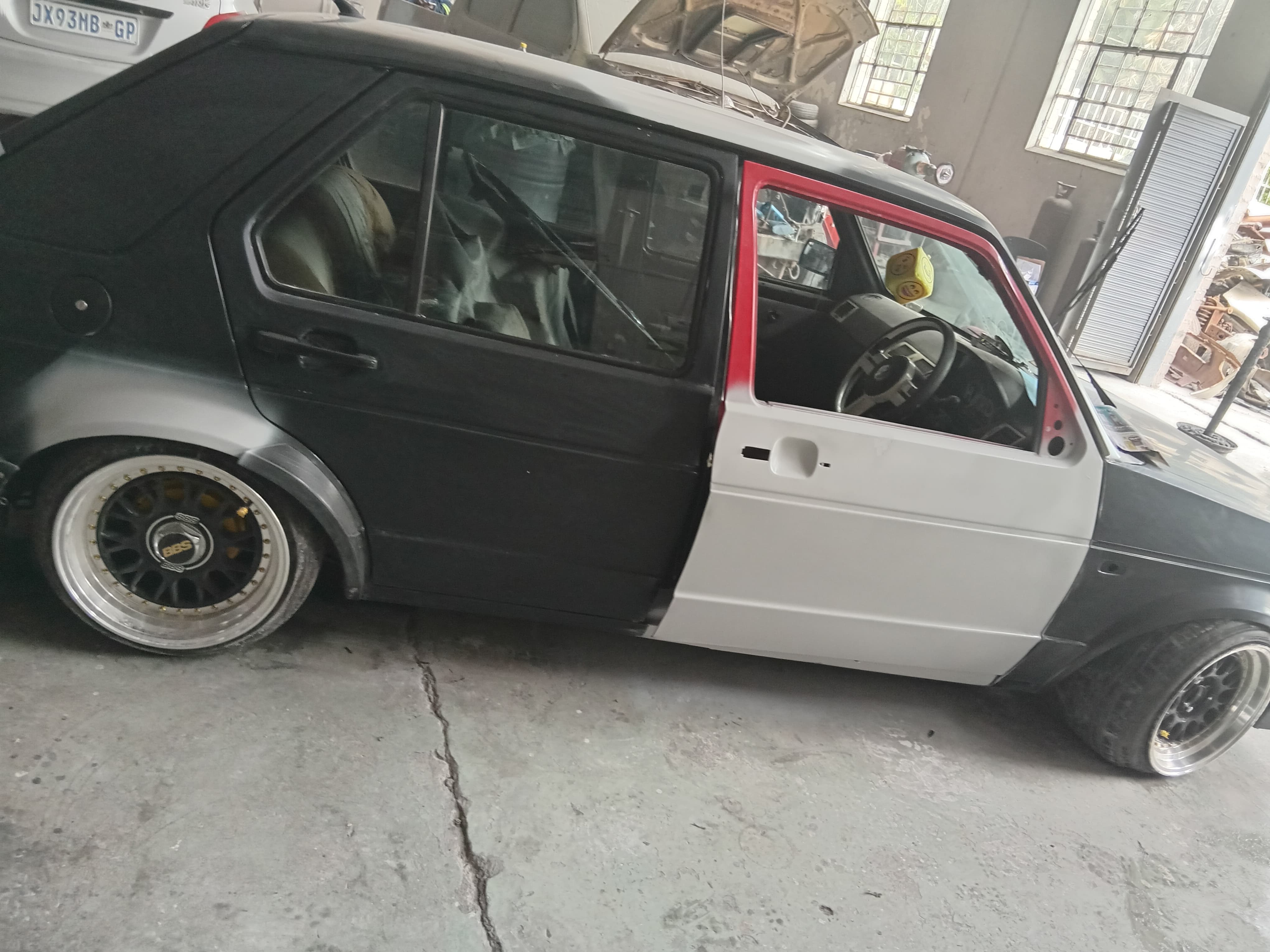 Vehicle undergoing multi-panel body preparation in the workshop