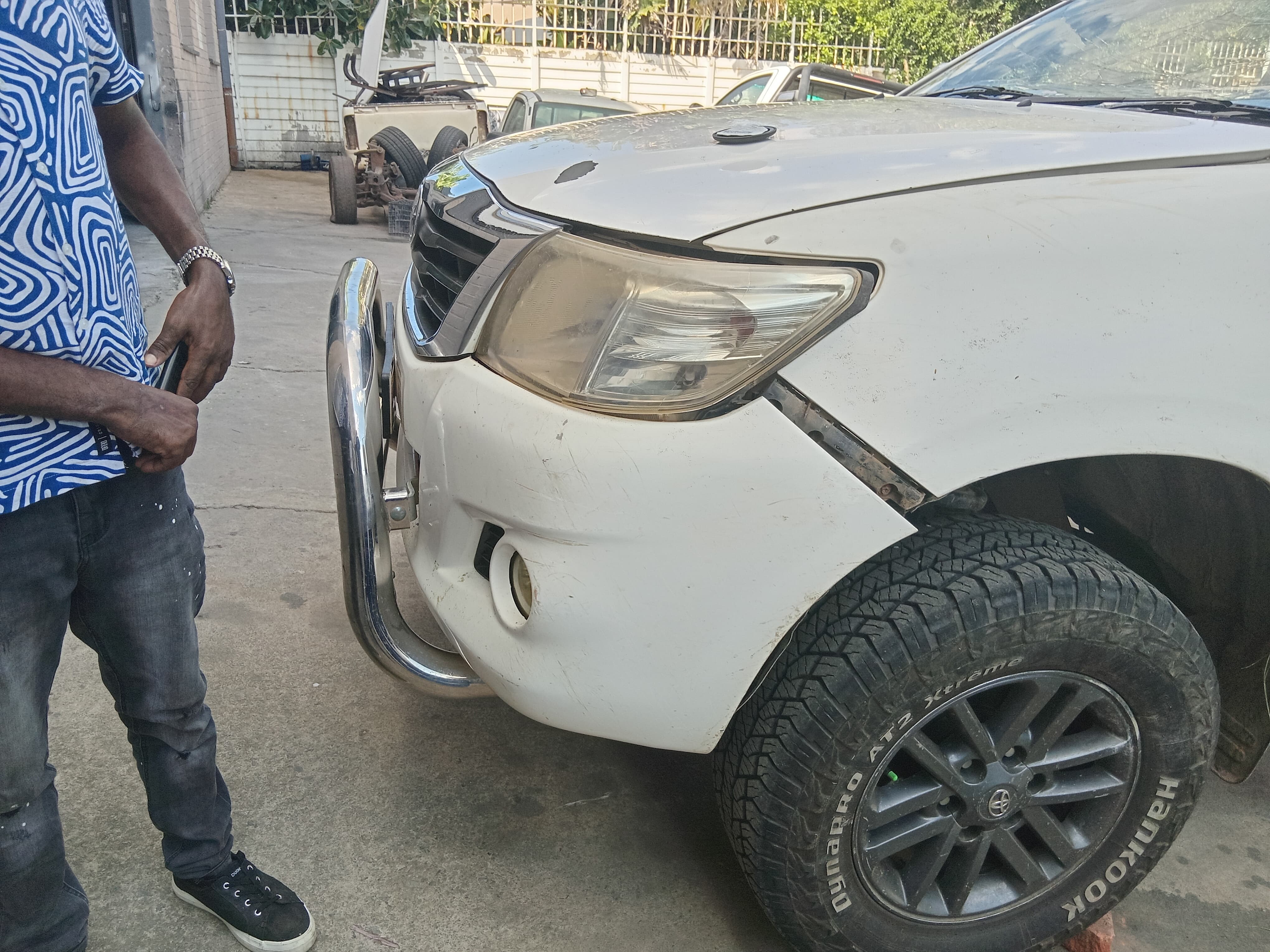 Pickup with damaged front bumper and misaligned body panel
