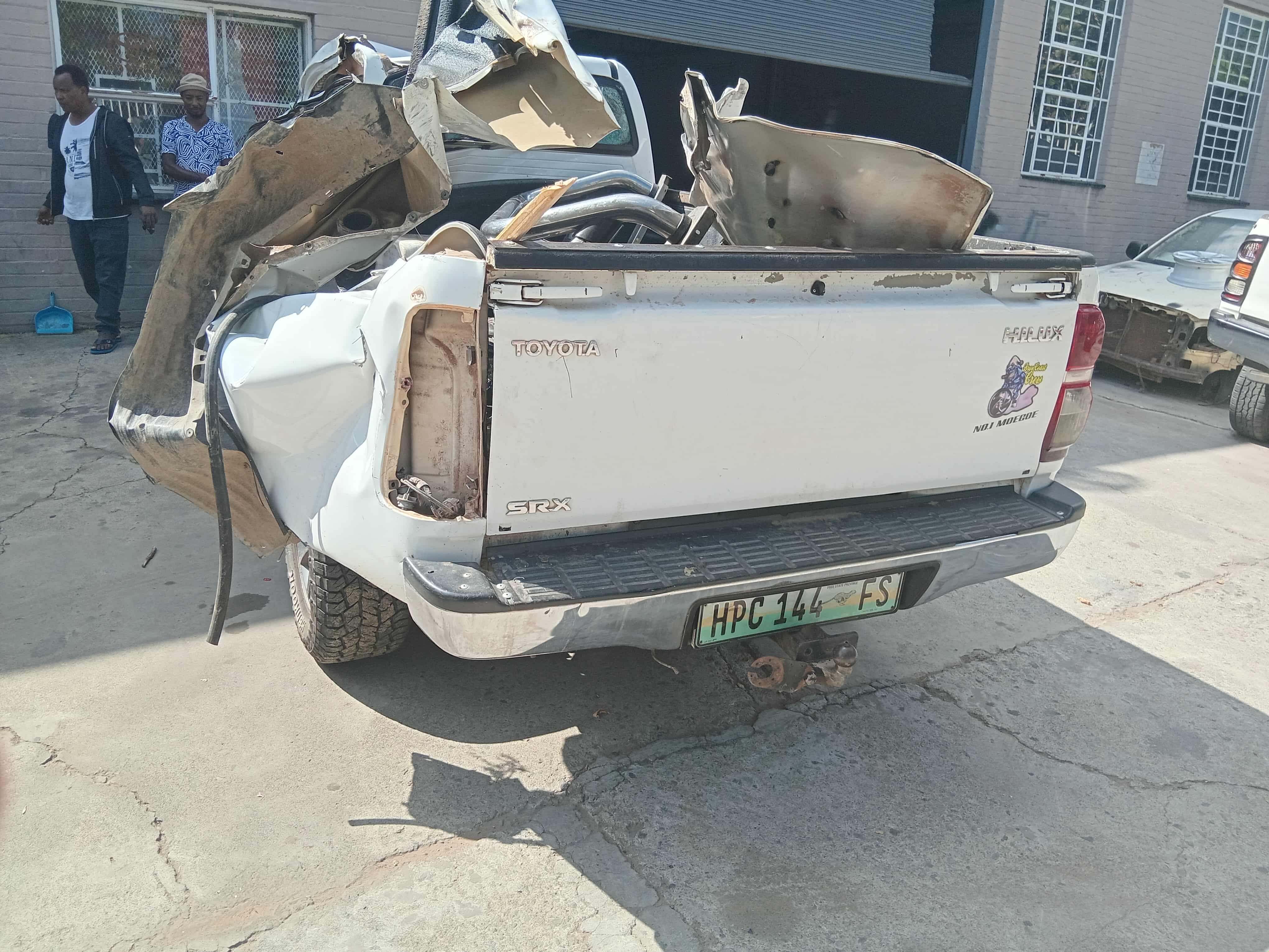Rear view of pickup with extensive accident damage